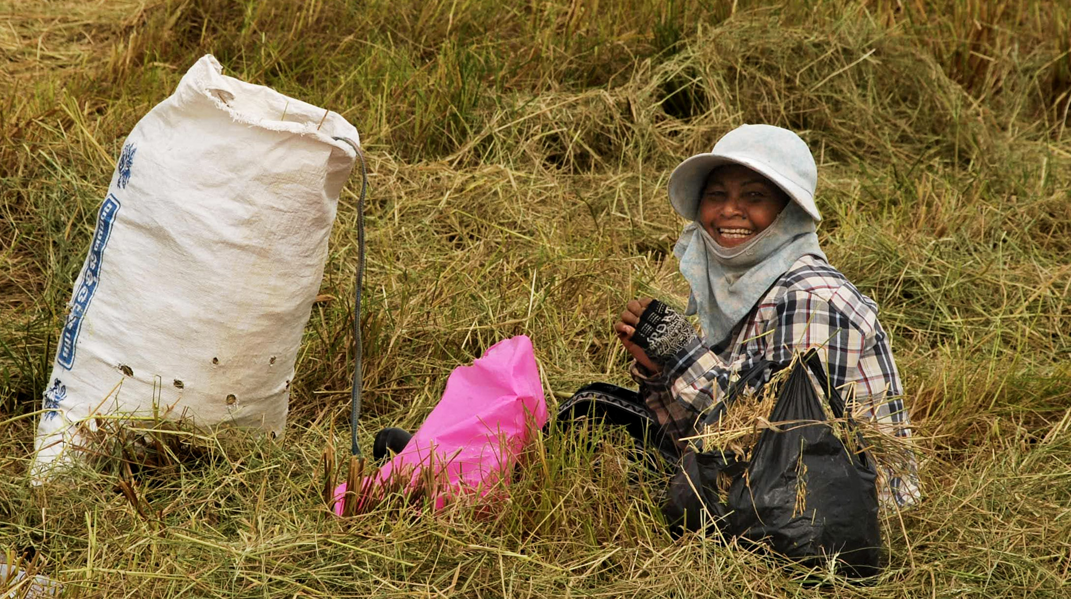Happy rice farmer greeting cyclists in Kampot